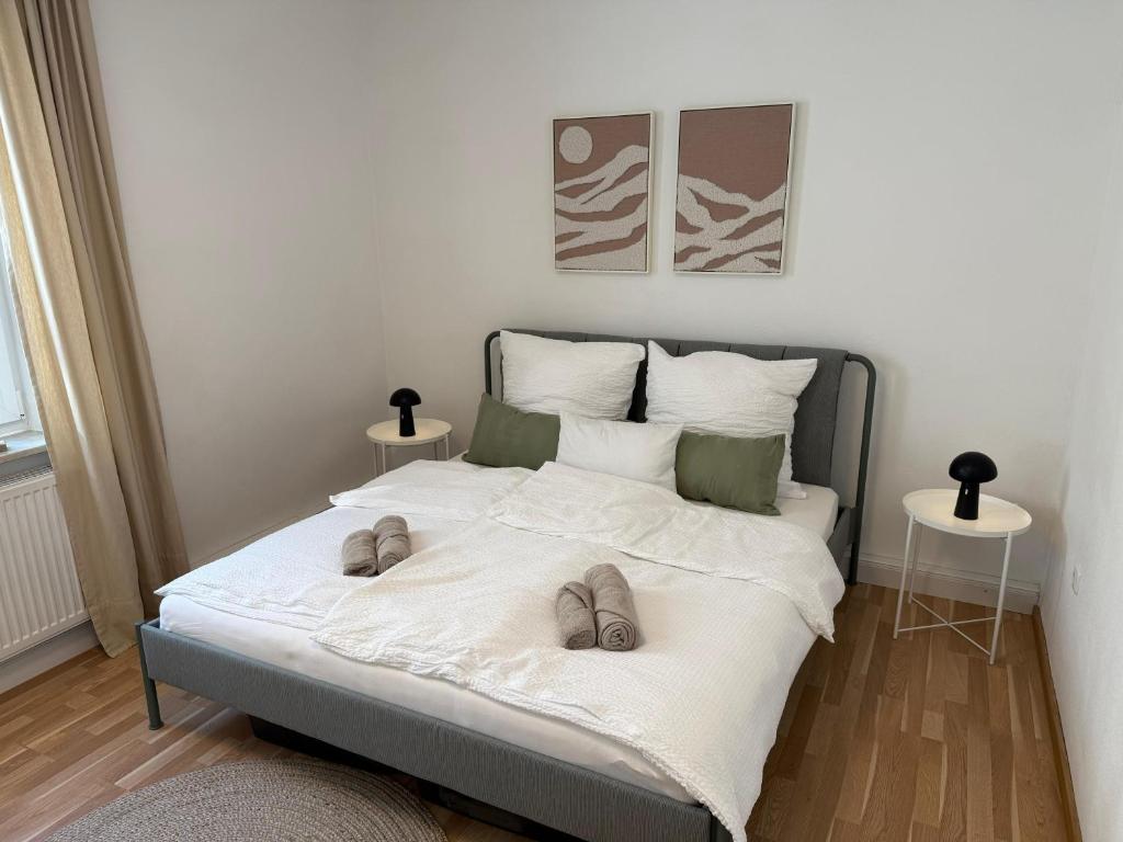 a bedroom with a bed with slippers on it at Zur Hirschstraße 10 in Haslach
