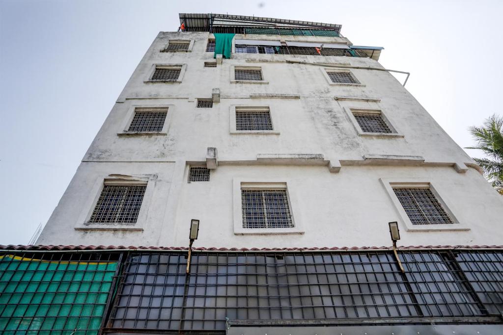 a tall white building with a lot of windows at Hotel O DREAMZZ INN in Nagpur