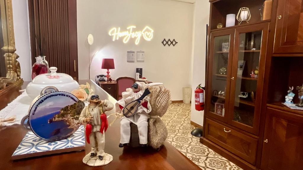 Una habitación con dos figuras y un espejo sobre una mesa. en Home Jocy Apartment with Free Parking, en Castellammare di Stabia