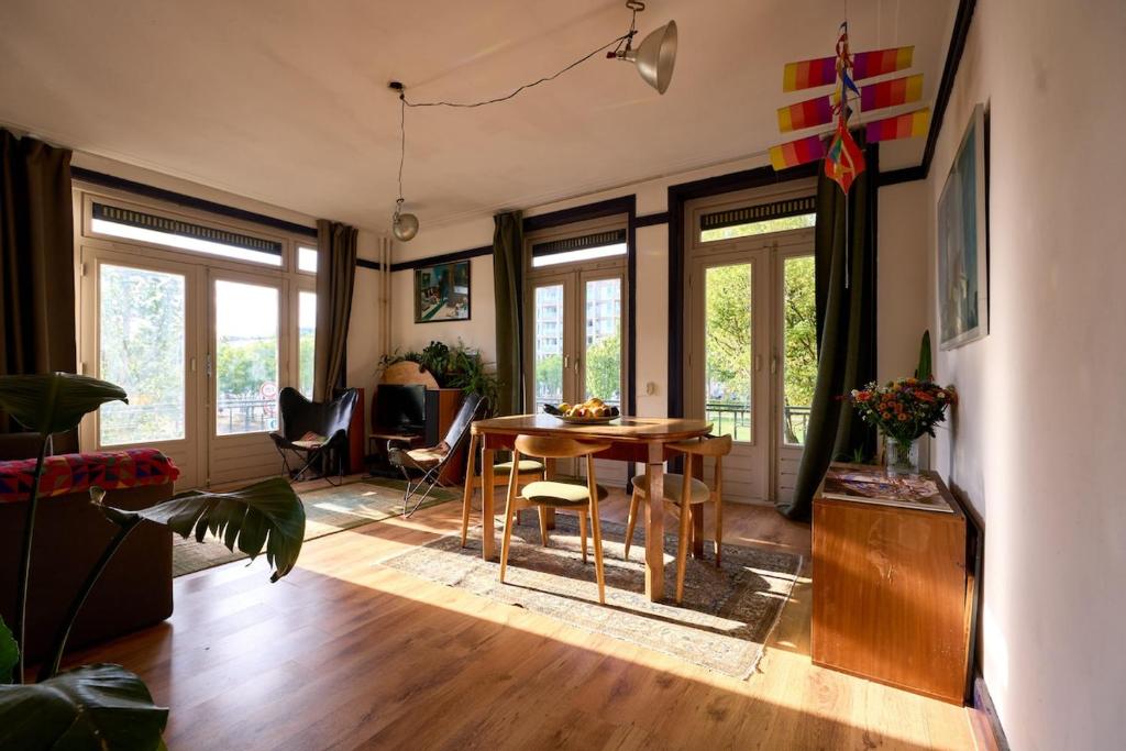 een woonkamer met een tafel en stoelen bij Olympic's Little Palace in Amsterdam