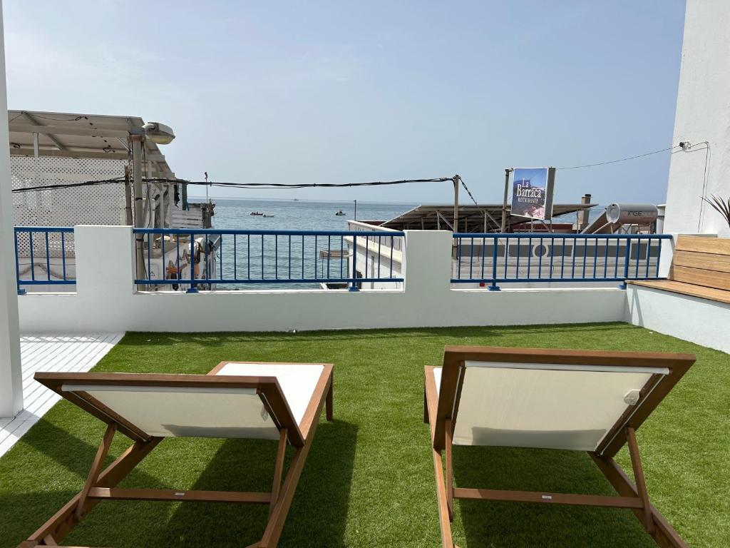 two chairs on a balcony with a view of the ocean at Vida in Tarajalejo