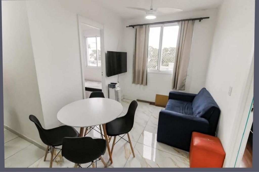 Una sala de estar con un sofá, una mesa y sillas. en Apartment in Morumbi, en São Paulo