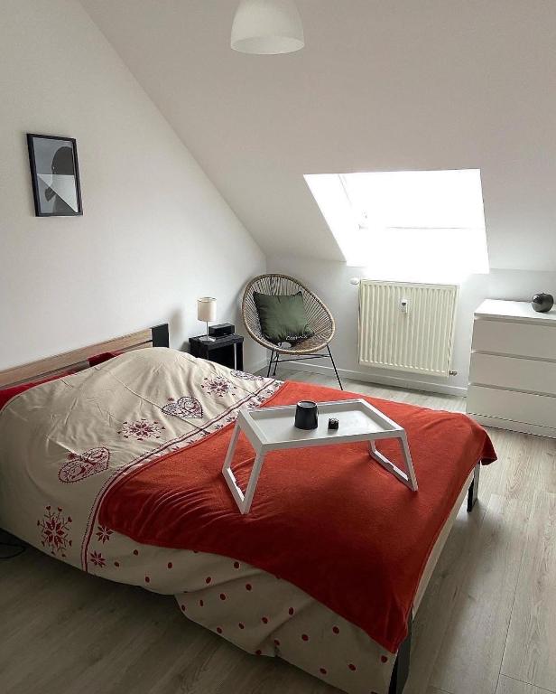 a bedroom with a bed with a table on it at Les COSY Apparts in Contrexéville