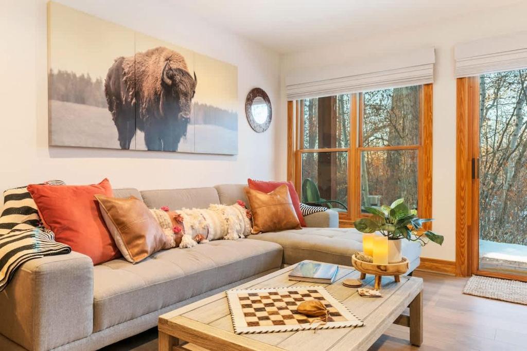 a living room with a couch and a table at Basecamp Stays: Upscale Getaway Shuttle Hot Tubs in Alta