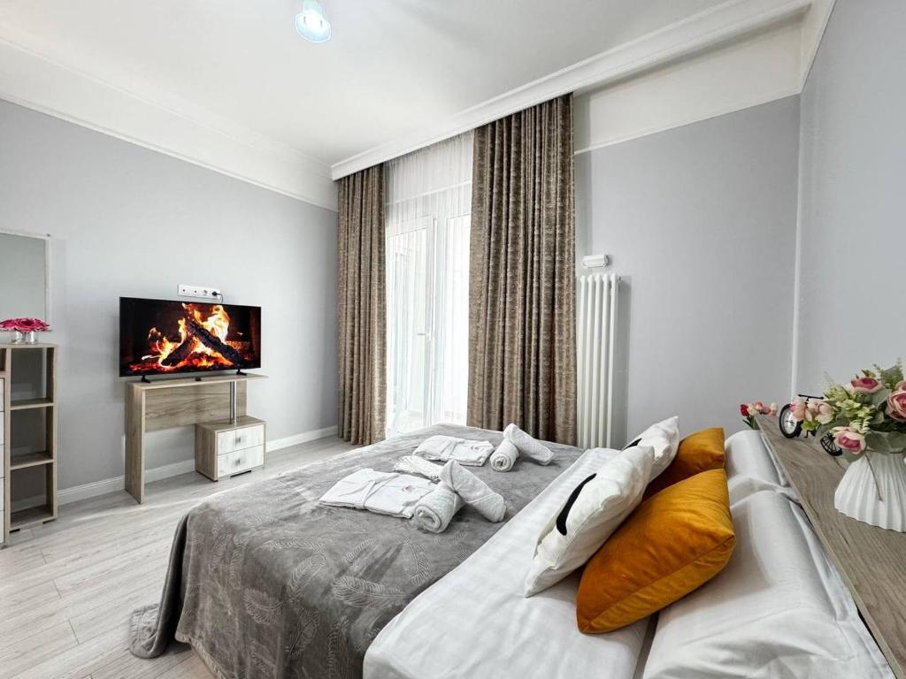 a bedroom with a bed and a tv on the wall at 2 room apartment near MEGA, ЖК 4 YOU, flat 163 in Almaty
