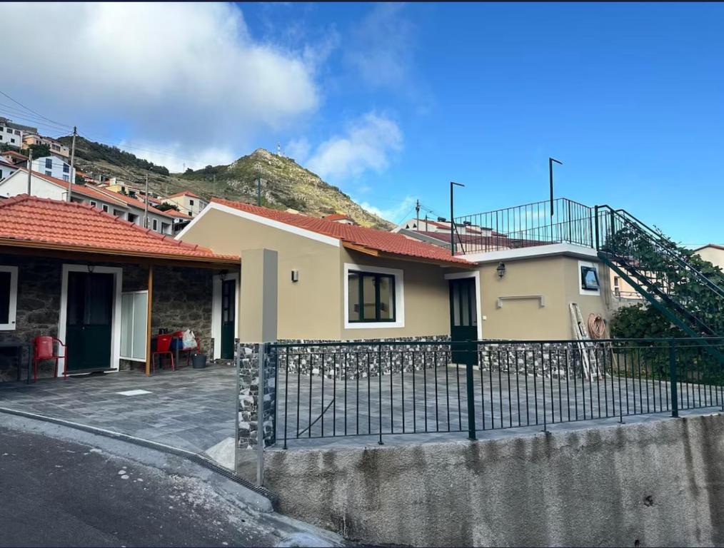 a house with a fence in front of it at Mocha House in Machico