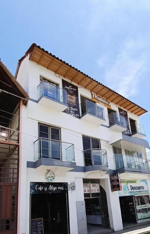 a white building with windows and balconies on it at HOTEL DEL PARQUE VELEZ Santander in Vélez