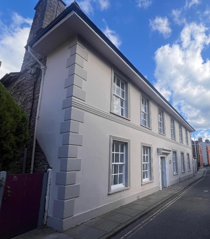 a white building with windows on a street at Cantre Selyf in Brecon