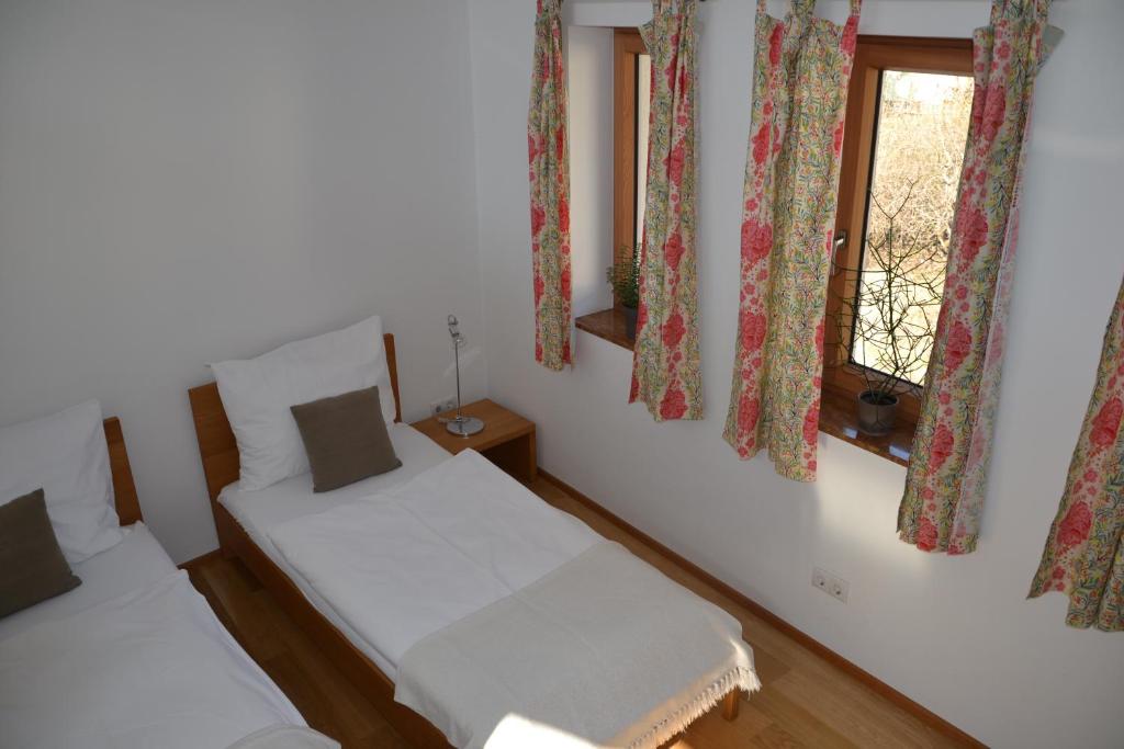 2 camas en una habitación con 2 ventanas en Wein + Bett Wiedeck, en Stetten