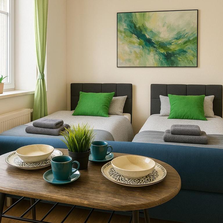 a living room with two beds and a coffee table at LENASTAY I City Comfort Apartment in Top Location in Kaiserslautern