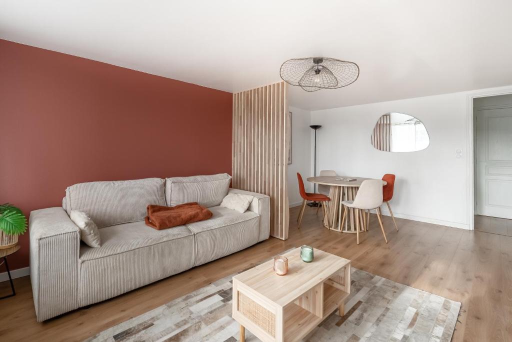 a living room with a couch and a table at Appartement devant Nausicaa in Boulogne-sur-Mer