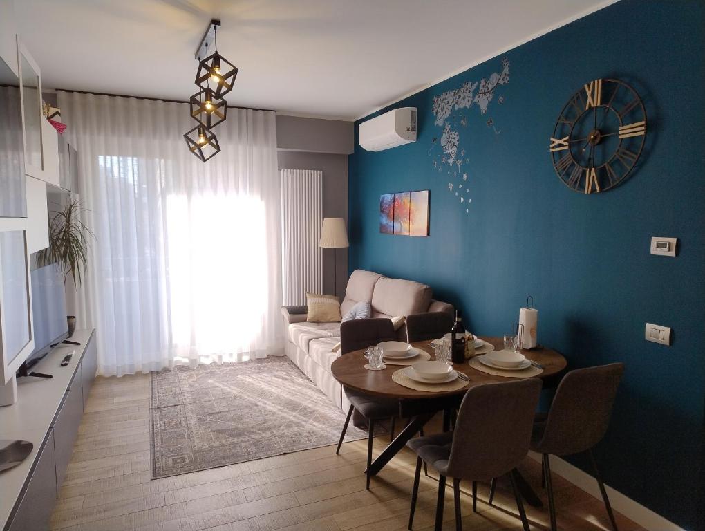 a living room with a table and a couch at Your Roman Holiday Home in Lido di Ostia