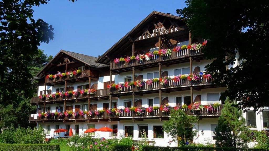 a hotel with flowers on the balconies of it at Hotel & Appartements Perwanger in Völs am Schlern