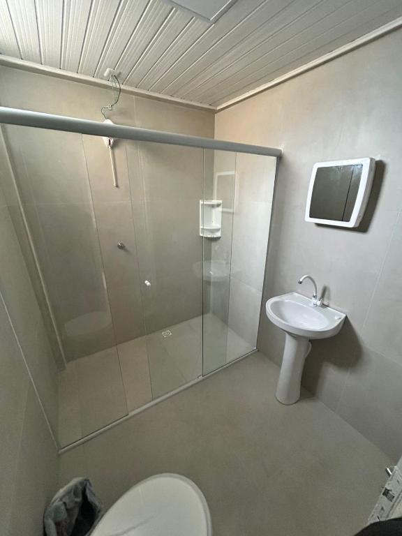 a bathroom with a shower and a toilet and a sink at Suíte da paz in Lauro Müller