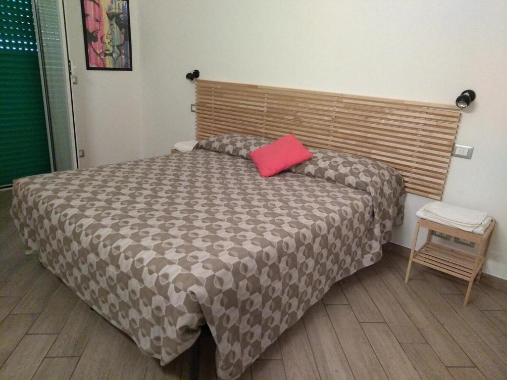 a bedroom with a bed with a red pillow on it at A&V Apartment in Santa Margherita Ligure