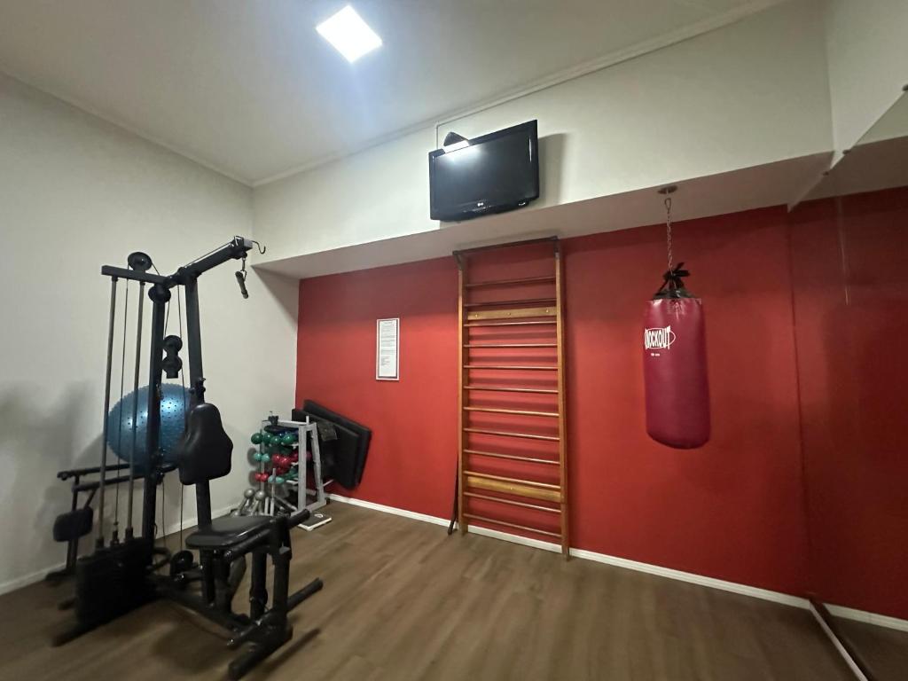 a gym with a punching bag hanging from the ceiling at Flat poeta Drumond in Sao Paulo