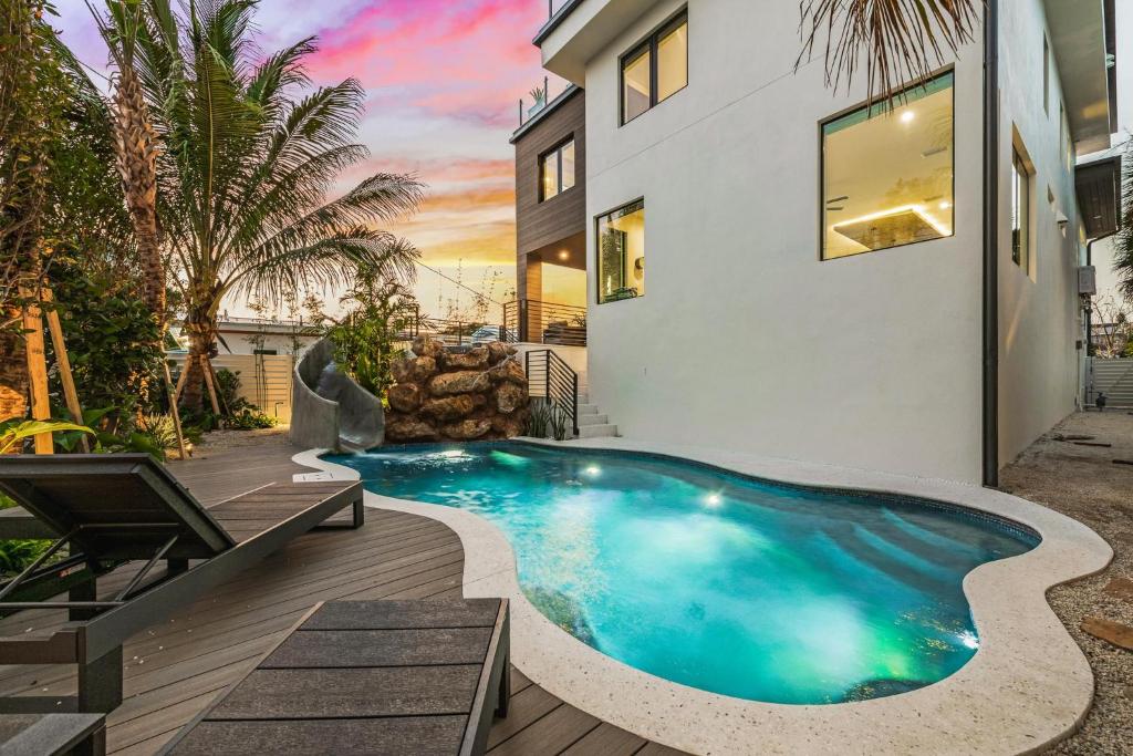 a swimming pool in the backyard of a house at Knot A Basic Beach House in Bailey Hall
