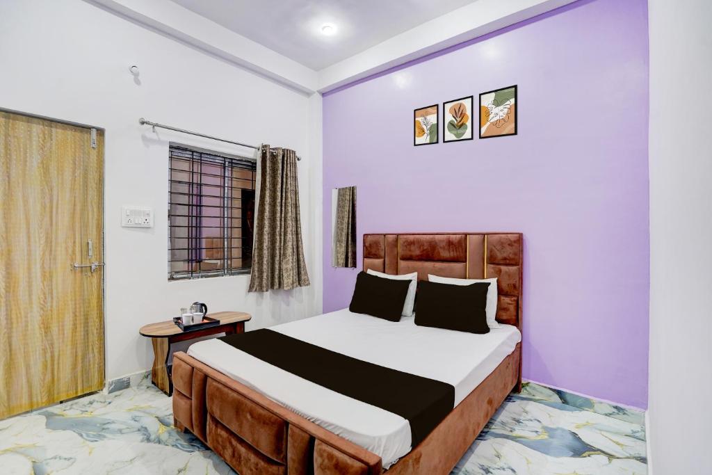 a bedroom with a bed and a window at Hotel O MN Palace in Jabalpur