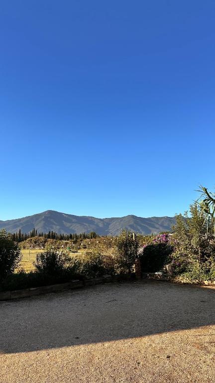 a view of a road with mountains in the background at Le Mas Del Cargol in Palau-del-Vidre