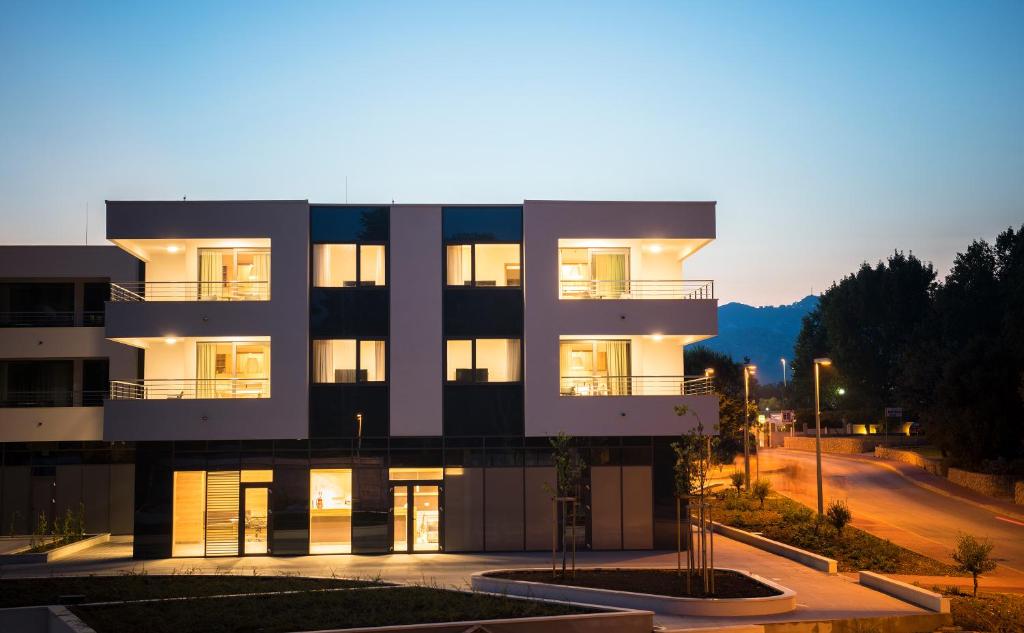 a night view of a building with lights on at Maistra Select Srebreno Premium Apartments in Mlini