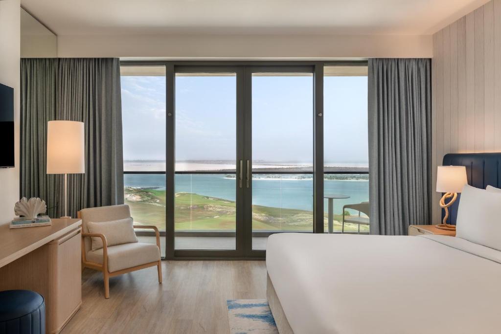 a hotel room with a bed and a view of the ocean at Crowne Plaza Yas Island by IHG in Abu Dhabi