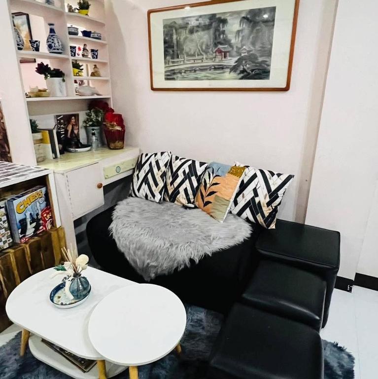 a living room with a couch and a table at Le Sorelle Staycation in Antipolo