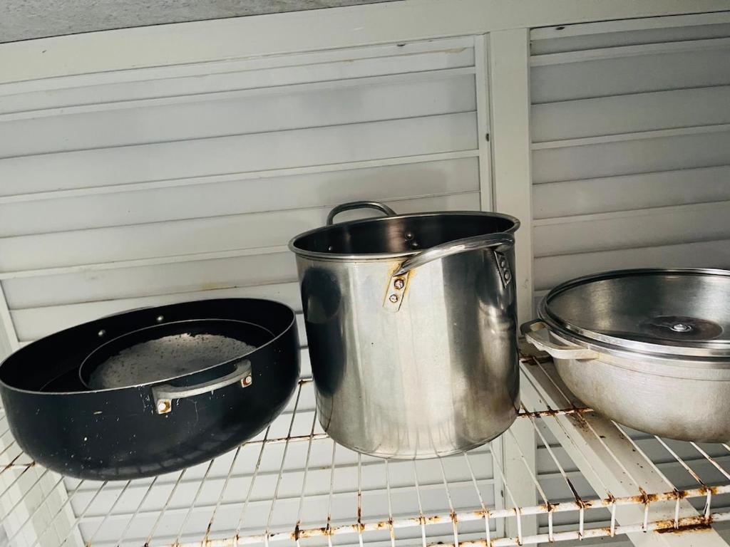 two pots and pans sitting on a cooling rack at Luxury Apartment 10 mn to SDQ Airport, the beach in Ensanche Savica de Mendoza