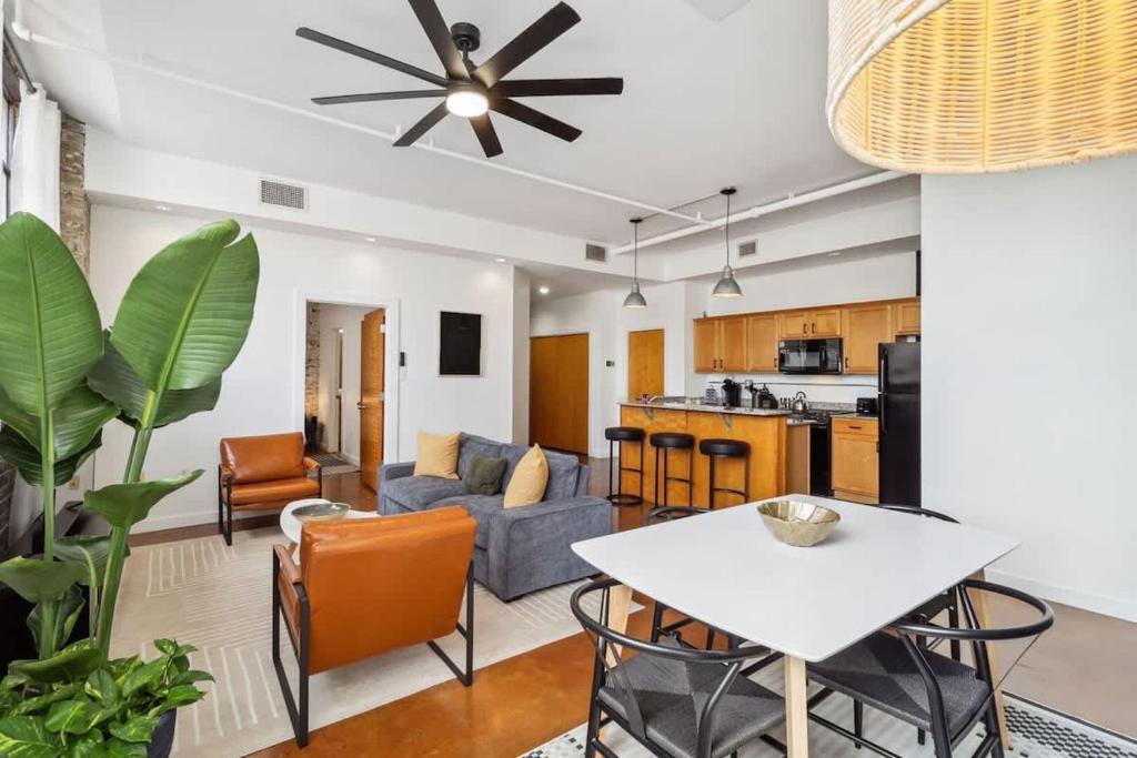a living room with a couch and a table at Stylish Industrial Loft in Warehouse District in New Orleans