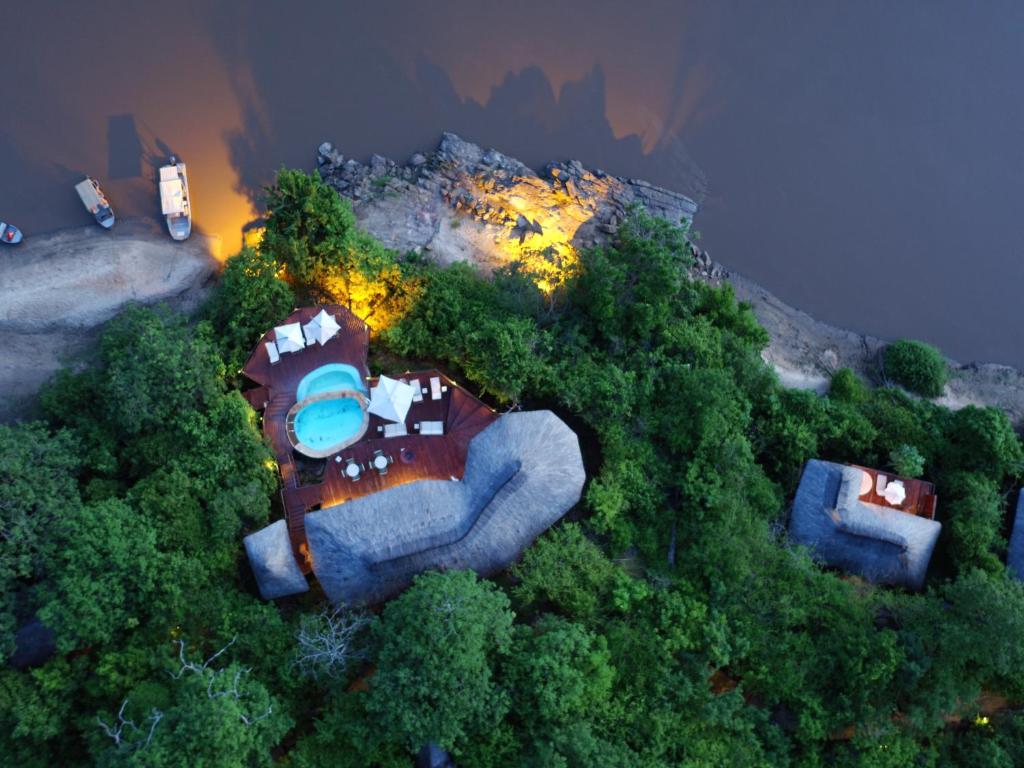 an overhead view of a house in the trees at Serena Mivumo River Lodge in Mkalinzu