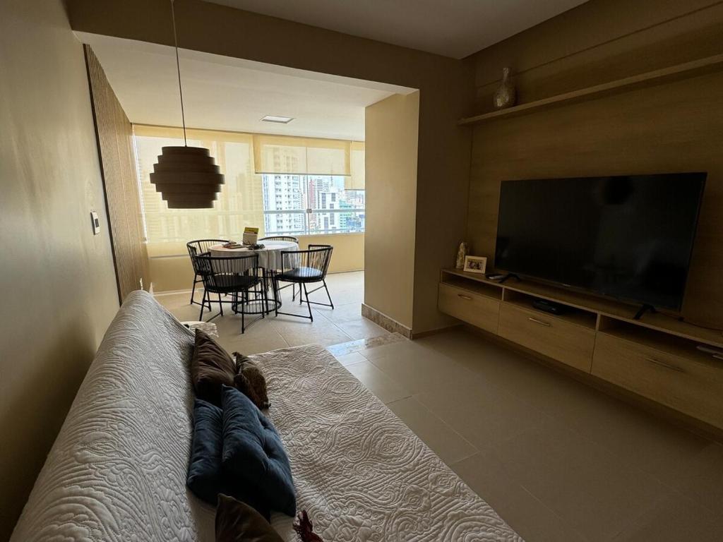 a living room with a couch and a television at Modern Condo Doca in Umarizal in Belém