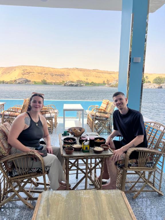 a man and a woman sitting at a table at Kafana Guest House Nile View in Aswan