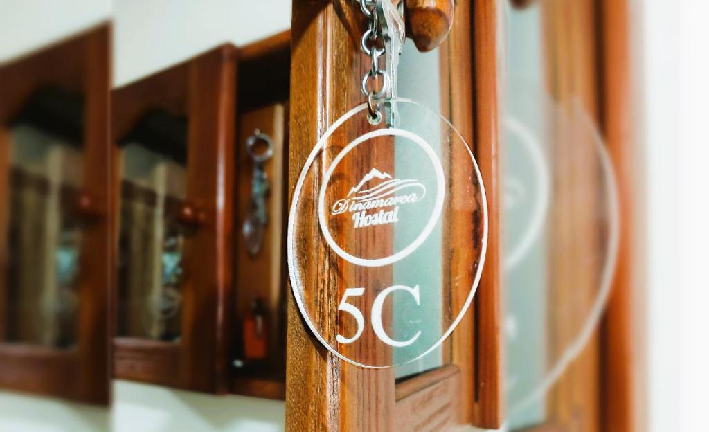 a wooden door with a sign on it at Hostal Dinamarca in Temuco