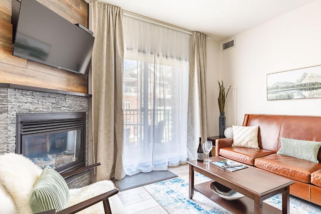 a living room with a couch and a fireplace at Westwinds - Funky Basecamp in the Rockies in Canmore