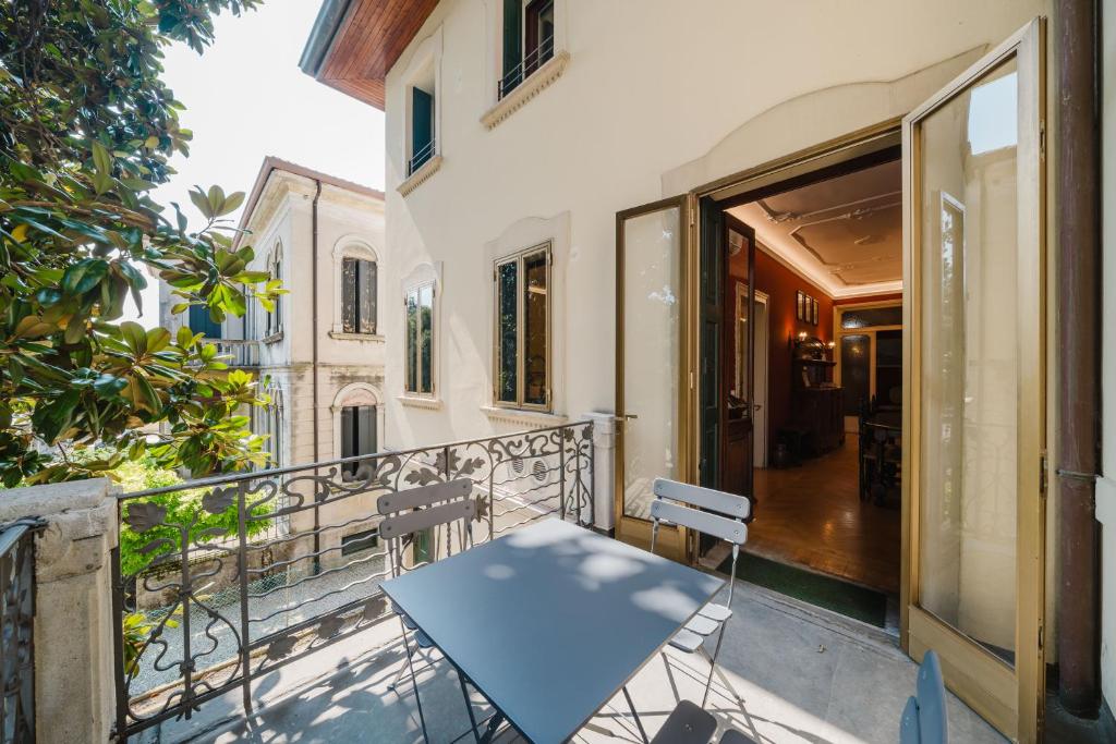 a table on the balcony of a house at Antico Villino - Elegant Accommodation with Parking in Conegliano