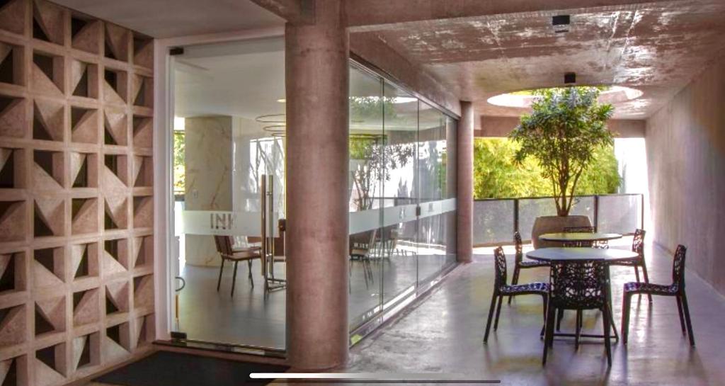 a dining room with a table and chairs in a building at Loft Blumenau in Blumenau