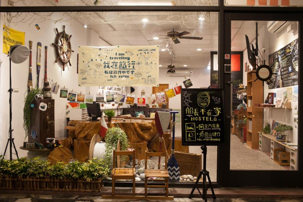 a store front of a store with signs on the window at Captain Not At Home in Hualien City