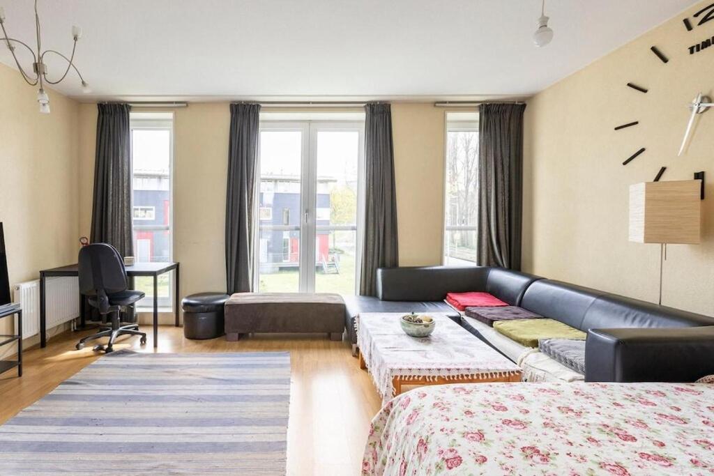 a living room with a couch and a bed at Delightfull spacious room in gorgeous home in Amsterdam