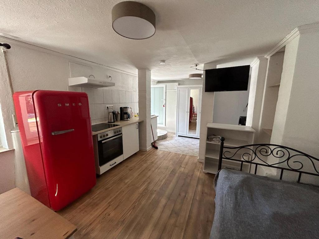 a kitchen with a red refrigerator in a room at Idyllic and quiet location in Obersulm