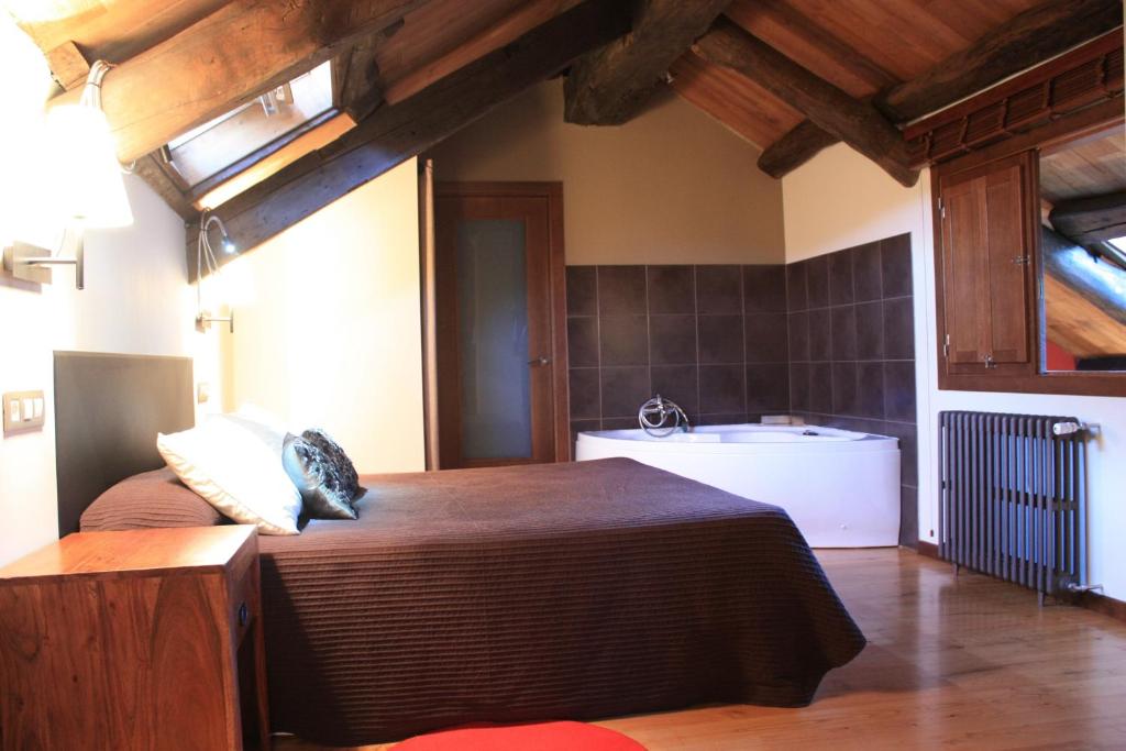 a bedroom with a large bed and a sink at Bi Terra tu descanso zona Miraz Sobrado in Friol