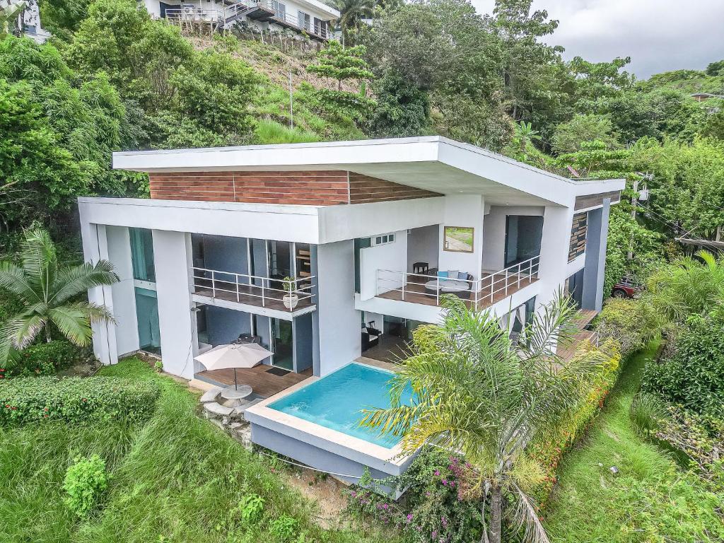 an aerial view of a house with a swimming pool at Luxury Villa Los Pajaros Private Pool & Oceanview in Playa Hermosa