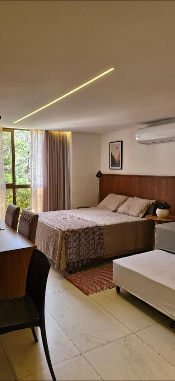 a bedroom with a large bed and a window at Unity 415 in João Pessoa
