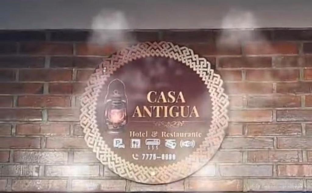 a picture of a sign on a brick wall at Hotel y Restaurante Casa Antigua in San Antonio Suchitepéquez