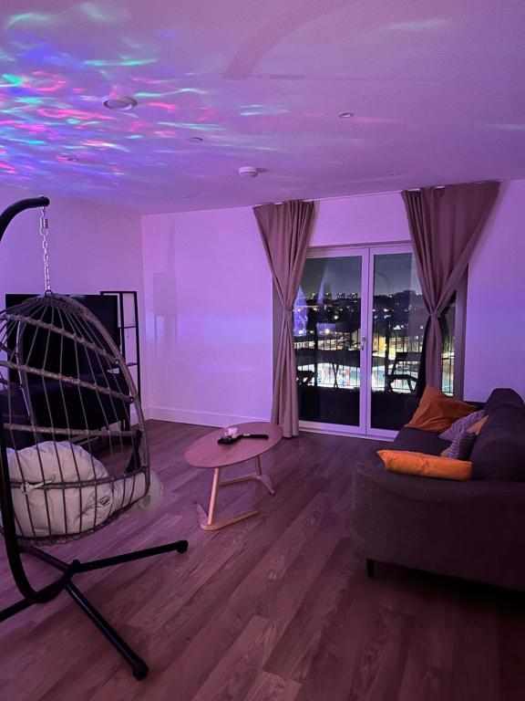 a living room with a couch and a table at Cozy one Bedroom with Views In Birmingham City Center in Birmingham