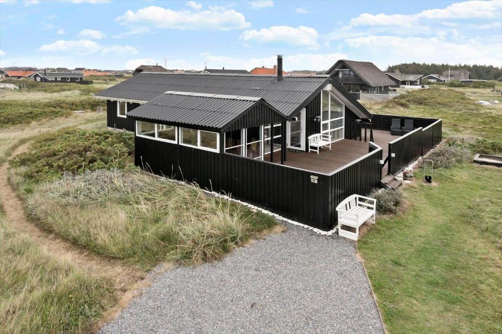 an overhead view of a black house in a field at 313-Harboore-Fourmivej-68 in Harboør