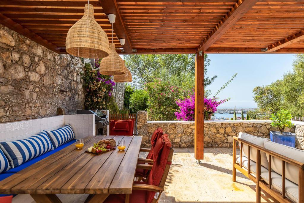 a wooden table and chairs on a patio at Sesimbra Blue Port Terrace - Comfort, Style, Pool, Ocean views in Sesimbra