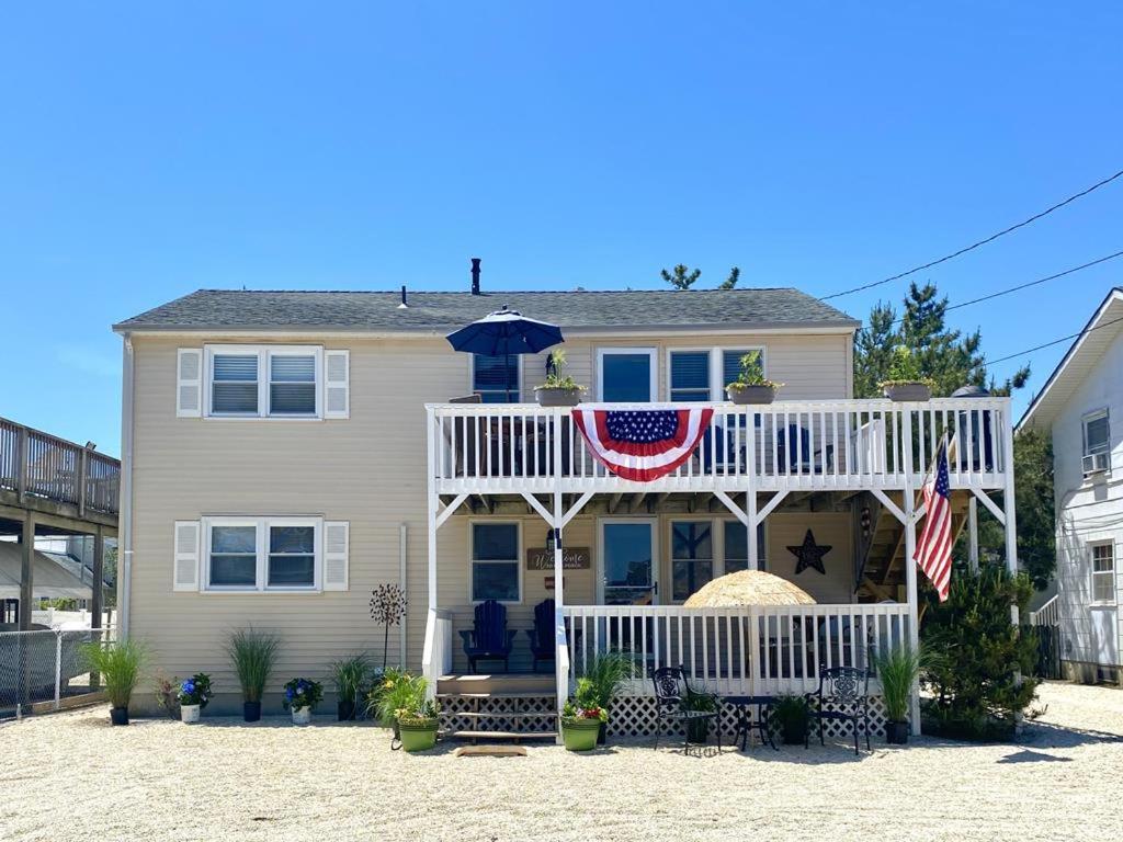 a house with an american flag on the porch at Lbi Vacation Rental Property in Beach Haven