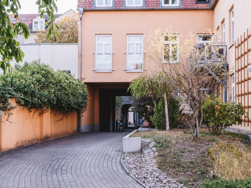 an entrance to a building with a brick driveway at Family accommodation in Dresden