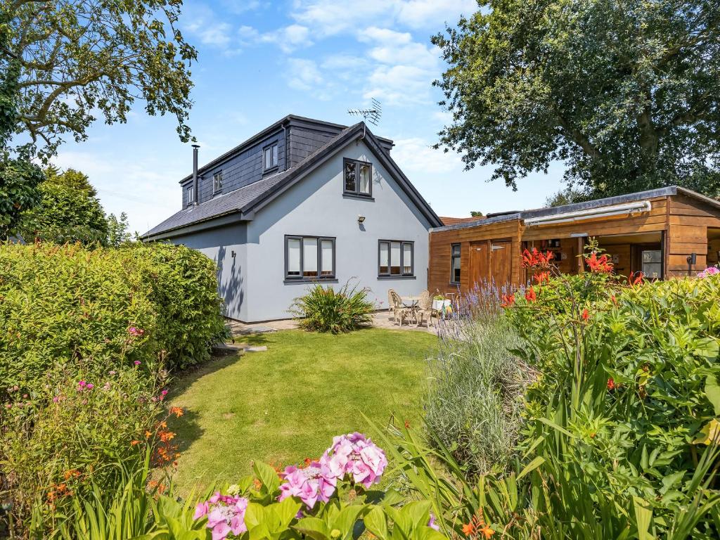 a white house with a garden in front of it at The Nook in Chapel Saint Leonards