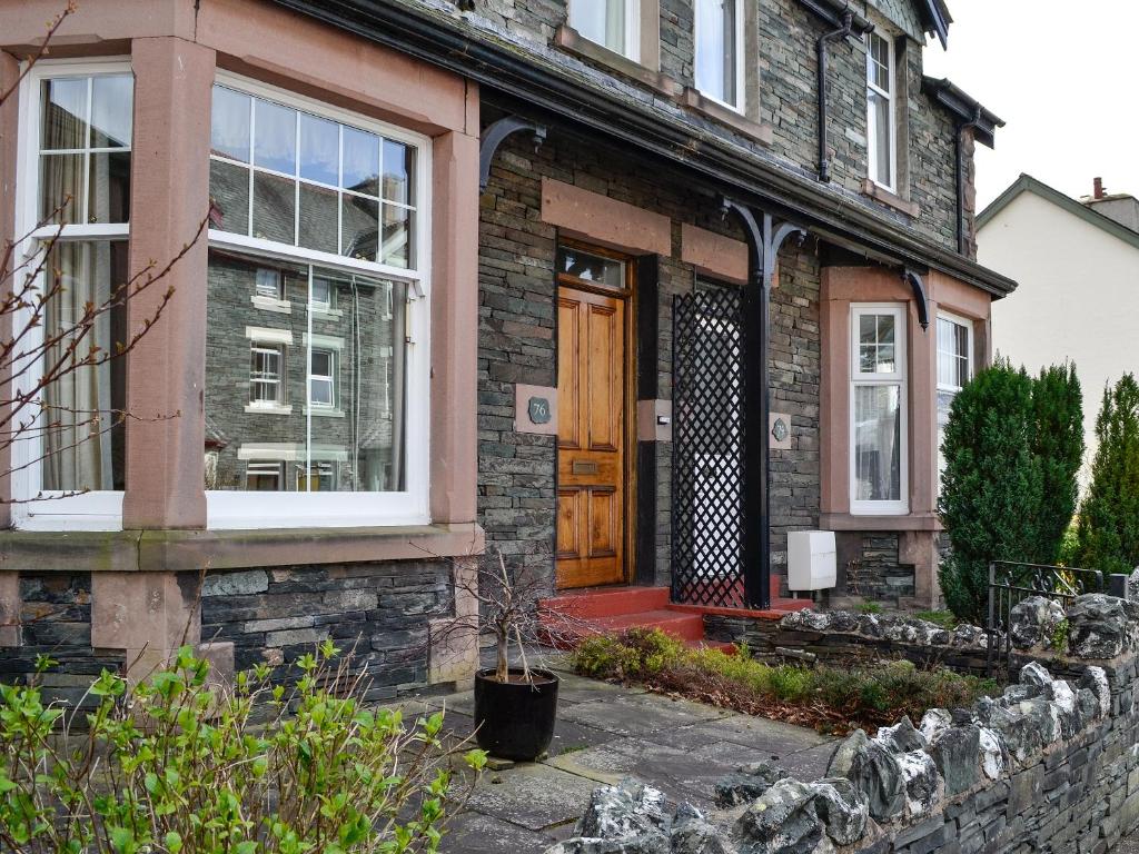 a brick house with a wooden door and windows at Robinson in Keswick