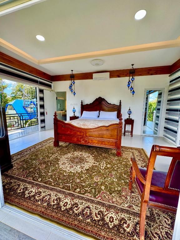 a bedroom with a wooden bed and a rug at Panika cozy rooms in Malaybalay